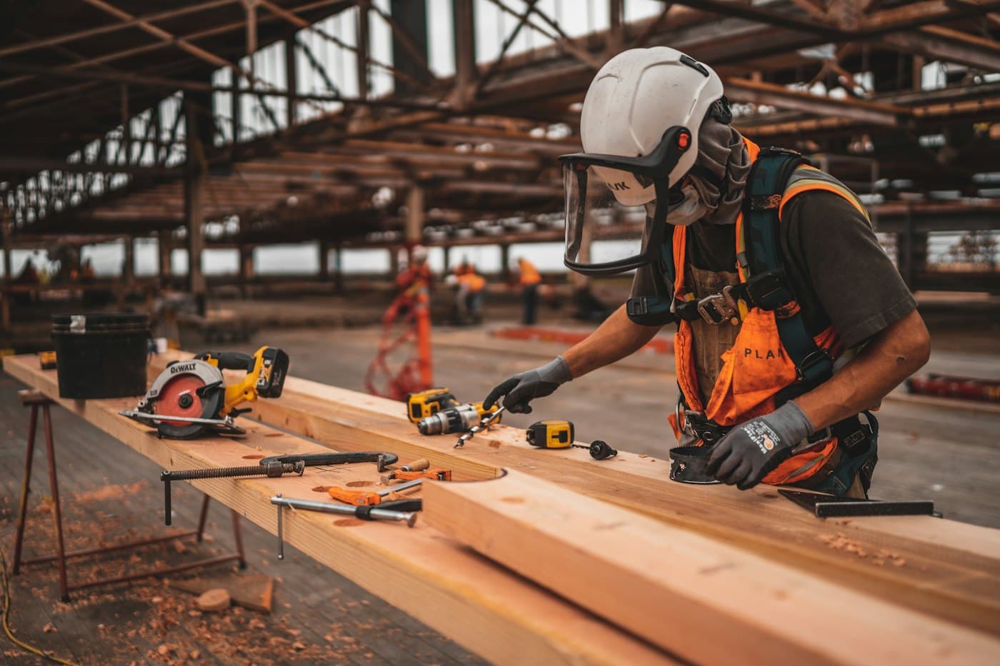 Tradesman measuring and cutting timber