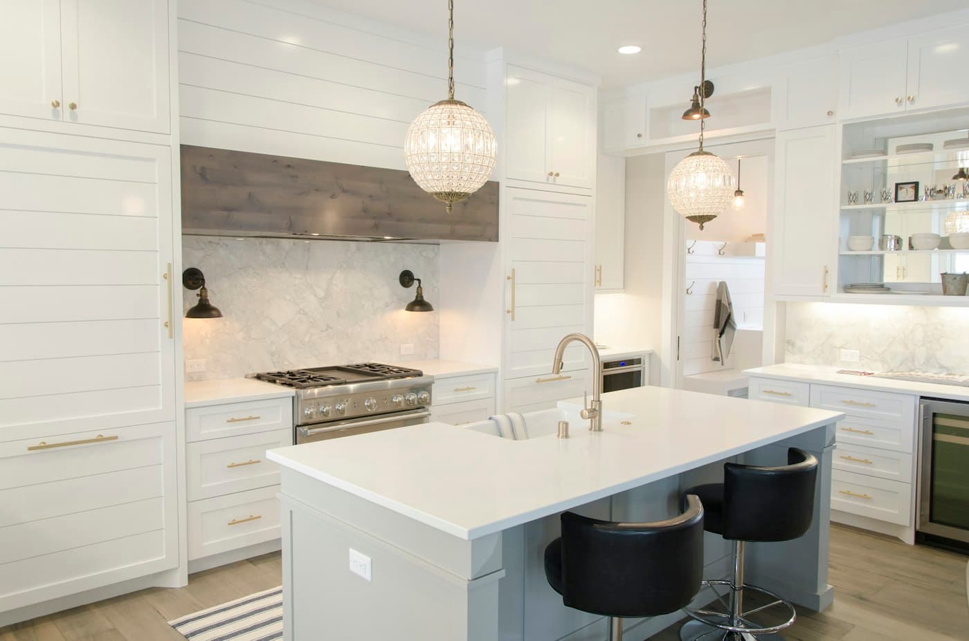 Renovated kitchen with marble island and pendant lights